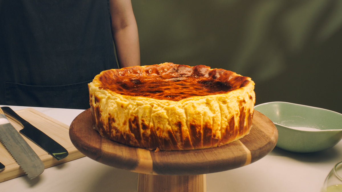 Classic Basque cheesecake on a wooden stand